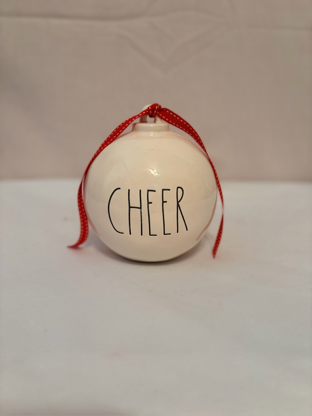 White ceramic Rae Dunn "CHEER" tabletop ornament